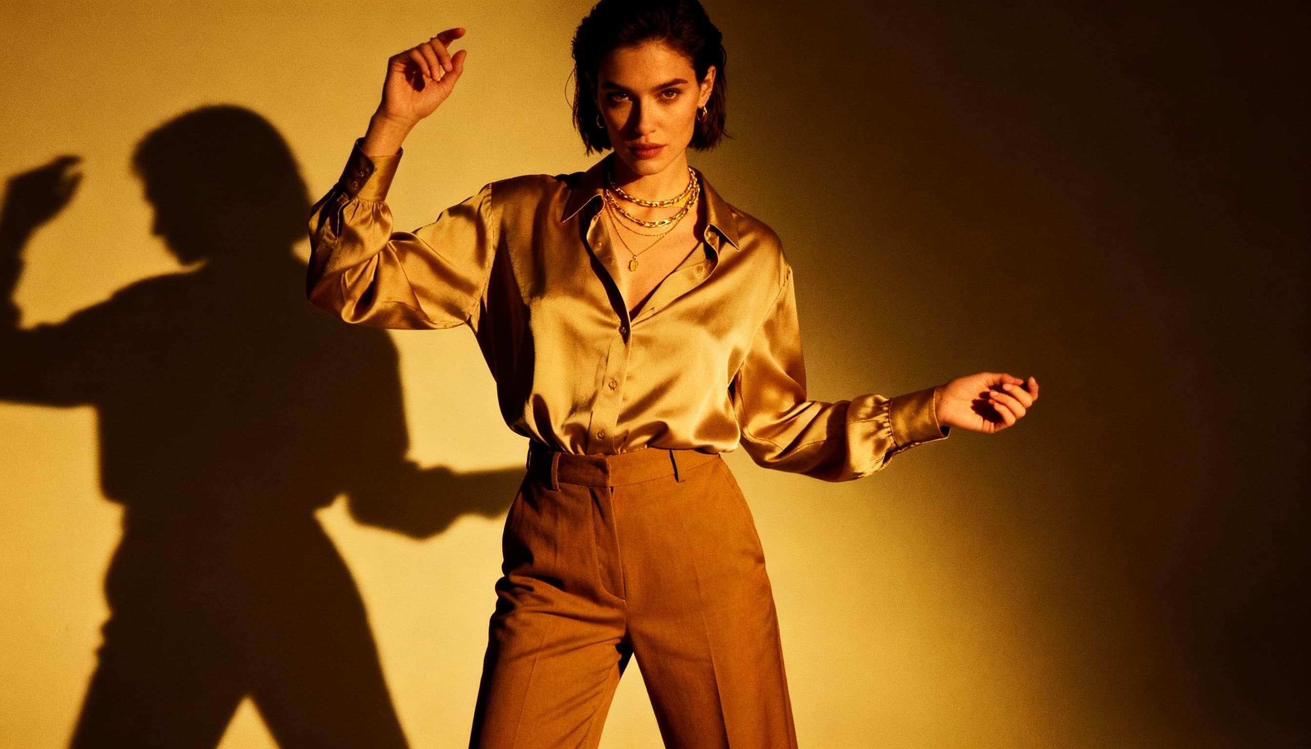 “Trendy women’s fabric pants outfit, straight-leg or wide-leg trousers, styled with tucked-in shirts or crop tops, layered jewelry, neutral-toned modern look, soft studio lighting, minimalist background, high-resolution fashion photography.”